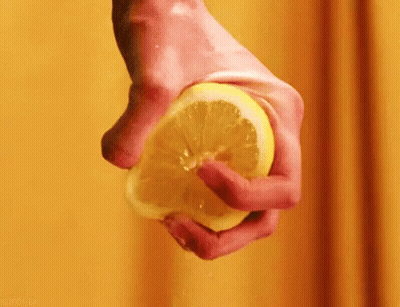 Person Squeezing Lemon GIF