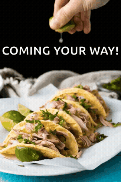 Person Squeezing Lime Over Tacos GIF