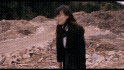 Person Squeezing Orange In Fist City Background Pause (N) GIF