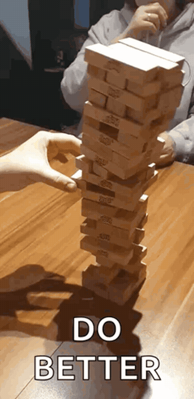 Person Stacking Wooden Blocks GIF