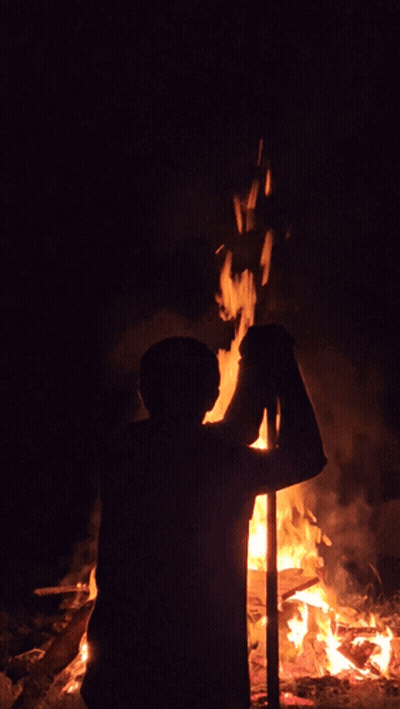 Person Standing Before Fire At Night GIF