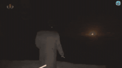 Person Standing Before Glowing Skull GIF