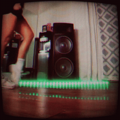 Person Standing Before Speaker With Green Light GIF