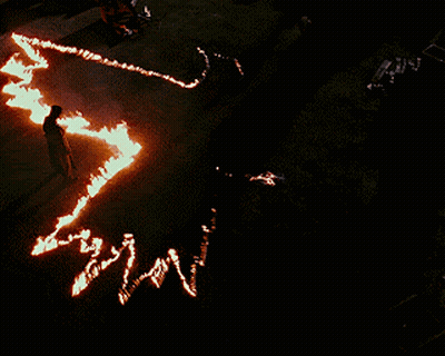 Person Standing In Circle Of Fire Map GIF