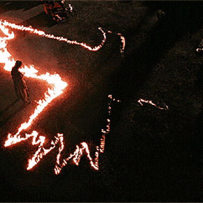 Person Standing In Circle Of Flames Saying Win GIF