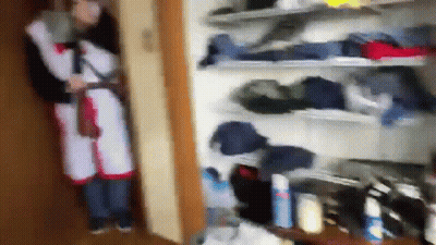 Person Standing In Closet With Clothes GIF