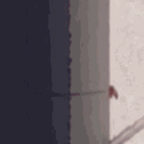 Person Standing In Dark Room Next To Door GIF