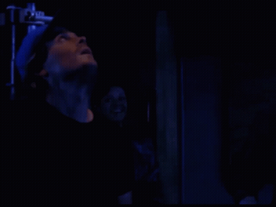 Person Standing In Dark Room With Blue Light GIF
