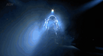 Person Standing In Dark Room With Light Shining GIF