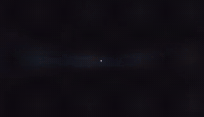 Person Standing In Dark Room With Light Shining GIF
