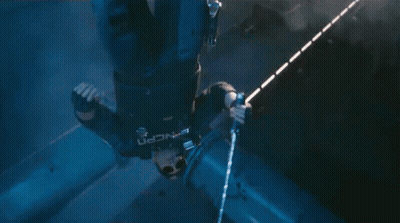 Person Standing In Dark Room With Purple And Blue Background GIF