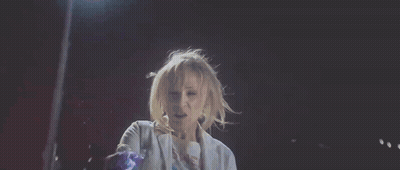 Person Standing In Dark Room With Purple Light From Chest GIF