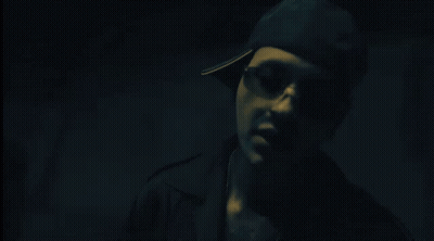 Person Standing In Dark Room With Red Exit Sign GIF