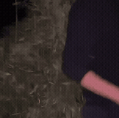 Person Standing In Dark With Arms Out GIF