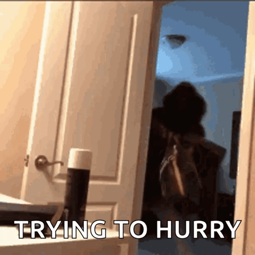Person Standing In Doorway Trying To Hurry GIF
