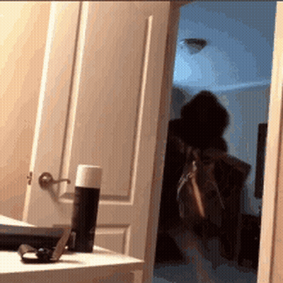 Person Standing In Doorway With Purse GIF