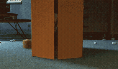 Person Standing In Doorway With TV Background GIF