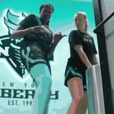 Person Standing In Front Of Blue Wall GIF