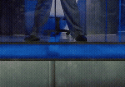 Person Standing In Front Of Blue Wall GIF