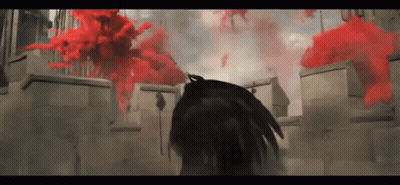 Person Standing in Front of Building With Red Smoke
