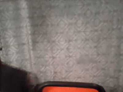 Person Standing In Front Of Curtain And Chair GIF