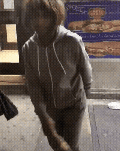 Person Standing In Front Of Dutz Station Sign GIF