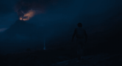 Person Standing In Front Of Fireball In Dark GIF