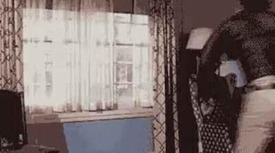 Person Standing In Front Of Window With Laptop GIF