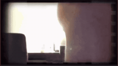 Person Standing In Front Of Window With Purple Background GIF