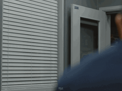 Person Standing In Front Of Window With R82 Sign GIF