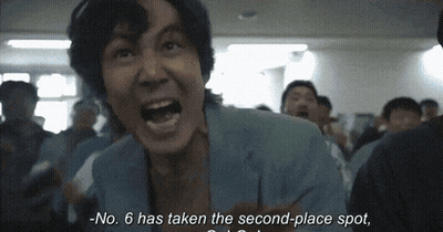 Person Standing In Hallway With Exit Sign GIF