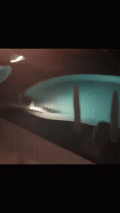 Person Standing In Pool At Night GIF