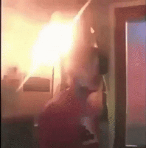 Person Standing In Room With Fire Ceiling GIF