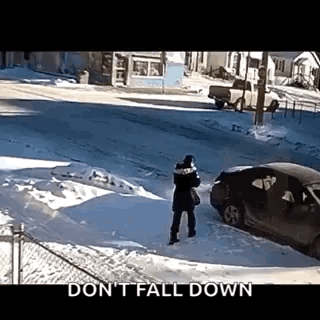 Person Standing in Snow in Front of Car