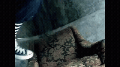 Person Standing Next To Patterned Chair GIF