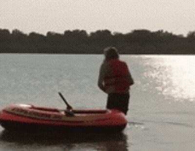 Person Standing Next To Raft Saying Rescue GIF