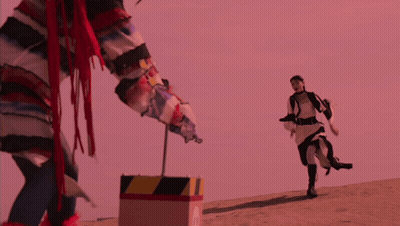 Person Standing Next To Yellow And Black Striped Box GIF