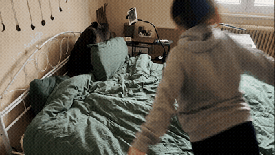 Person Standing On Bed With Tablet GIF