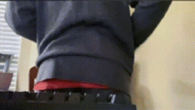 Person Standing On Chair With Outstretched Arms In Red Shirt GIF
