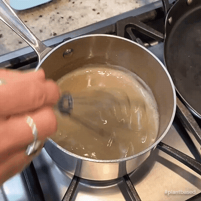 Person Stirring Liquid In Pot GIF