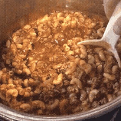 Person Stirring Macaroni And Cheese GIF