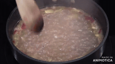 Person Stirring Pot Of Soup With Wooden Spoon GIF