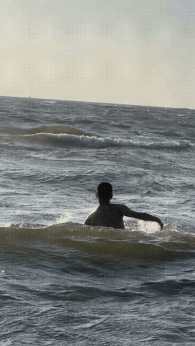 Person Swimming In Ocean With Arms Outstretched GIF