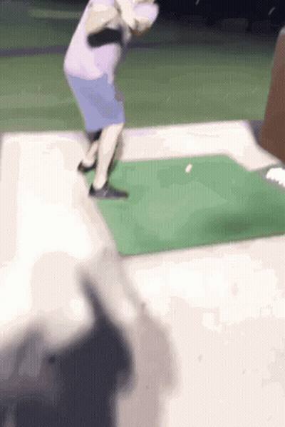 Person Swinging Golf Club At Ball GIF
