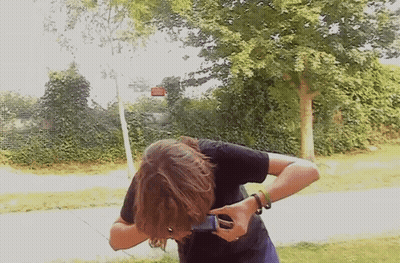 Person Taking Picture With Phone In Front Of Tree GIF