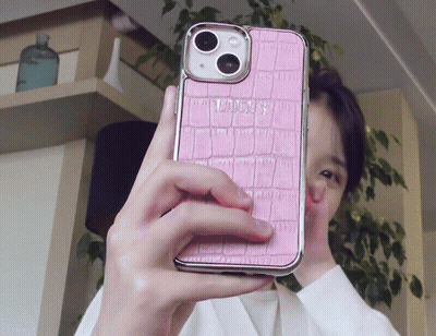 Person Taking Selfie With Pink Phone Case Saying Louis GIF