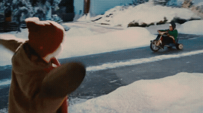 Person Throwing Snow At Tricycle Rider GIF