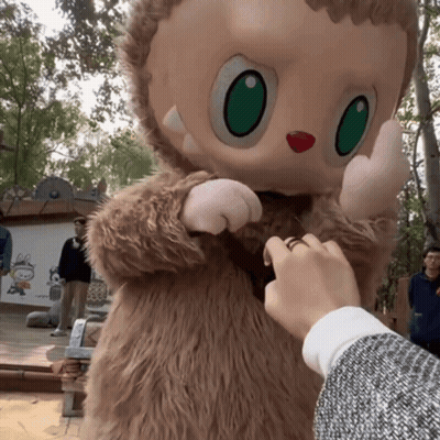 Person Touching Stuffed Animal With Green Eyes GIF
