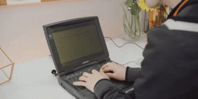 Person Typing On Compaq Laptop GIF