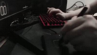 Person Typing On Keyboard In Front Of Dual Settings Monitor GIF